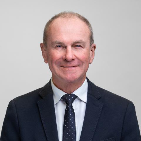 Close up portrait of Mark Hamilton-Smith on grey background